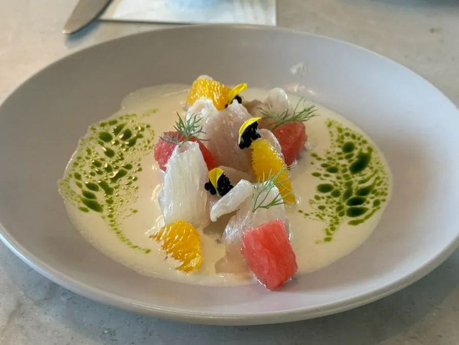 Plating of kelp-aged halibut carpaccio