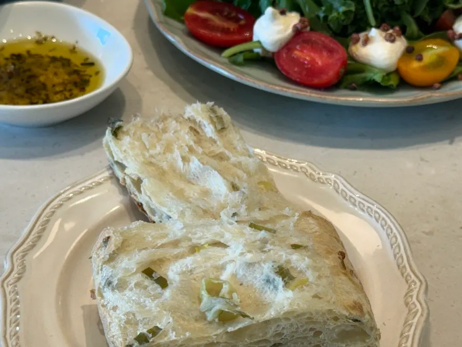 A plate of pine nut caprese salad
