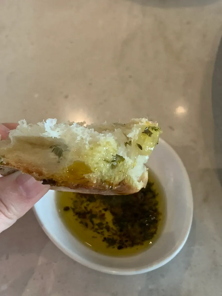 Pre-meal bread being dipped in olive oil