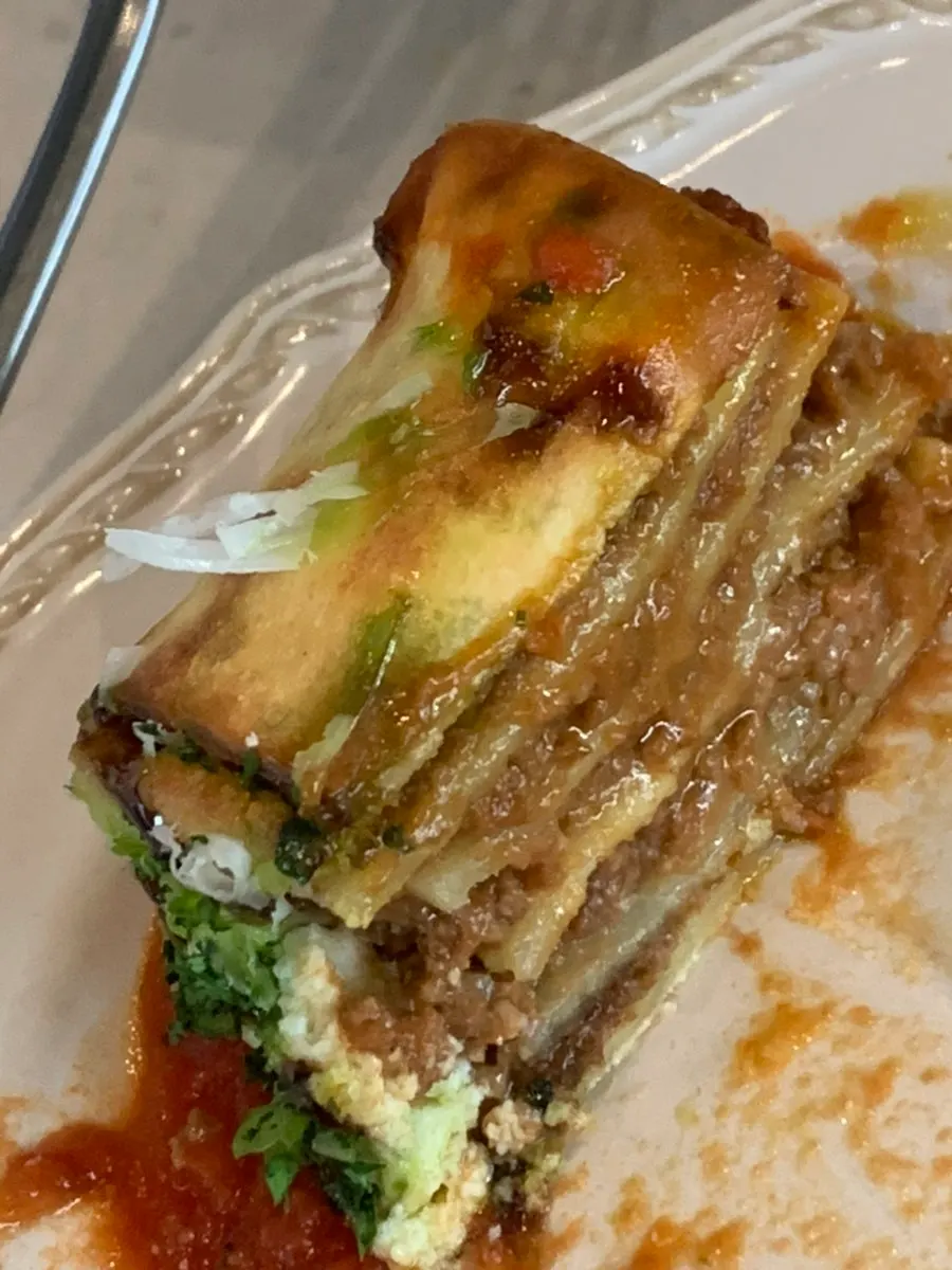 Lasagna roll served with ragu sauce and balsamic