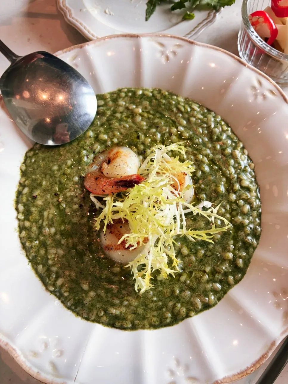 Maesaengi scallop risotto topped with scallops and shrimp