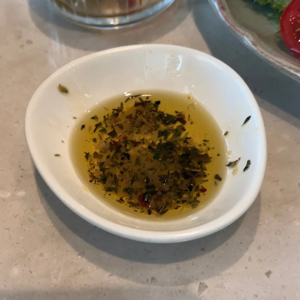 Close-up of Romaok bread dipped in garlic-scented oil