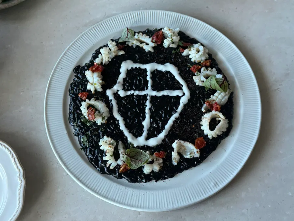 Plated eclipse squid ink risotto at Romaok Magok