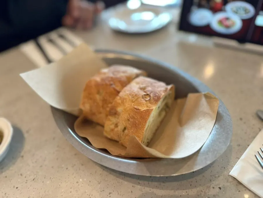 Green onion ciabatta bread served with herb oil before the meal