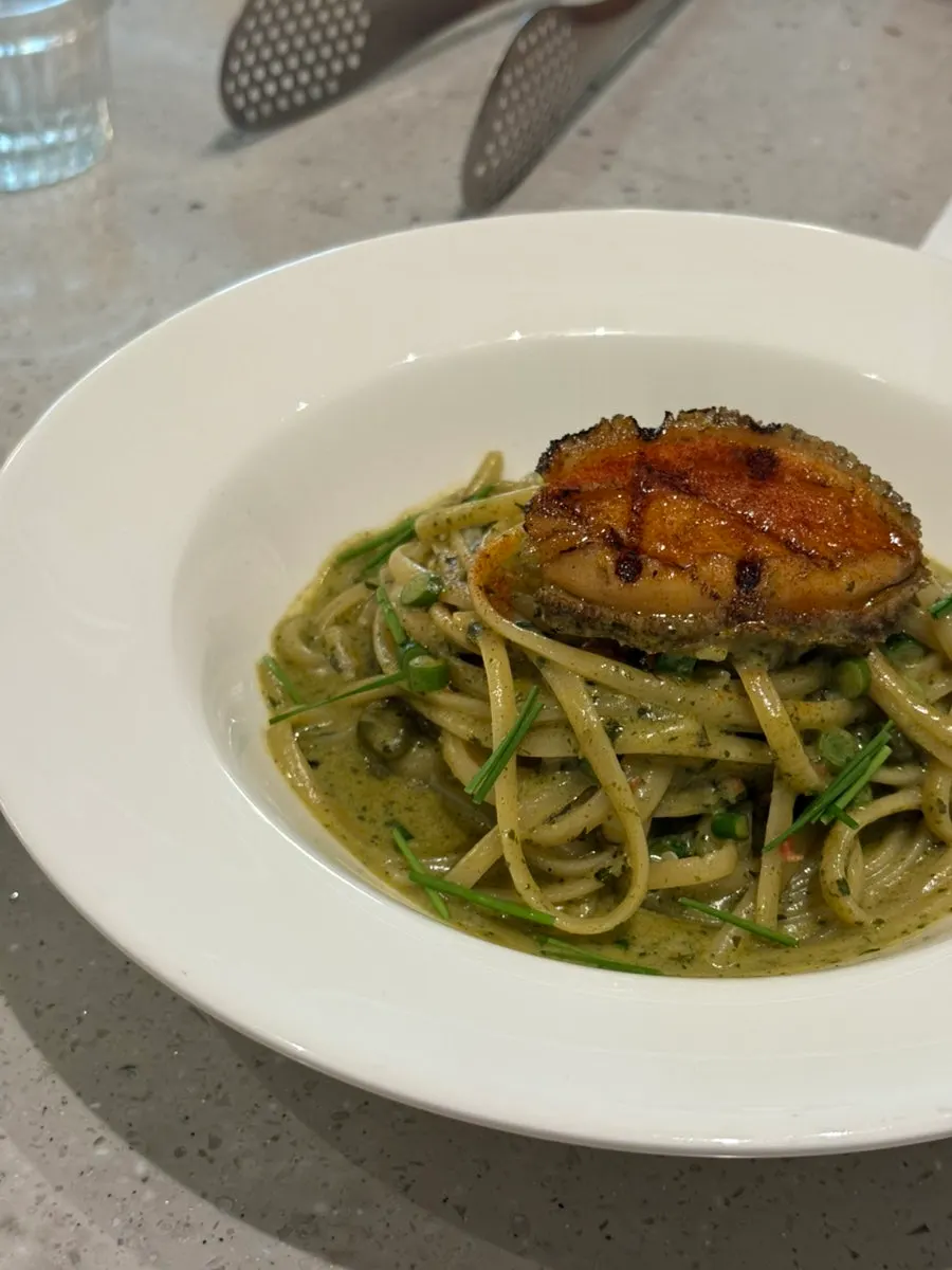 A plate of rich abalone geou cream sauce pasta
