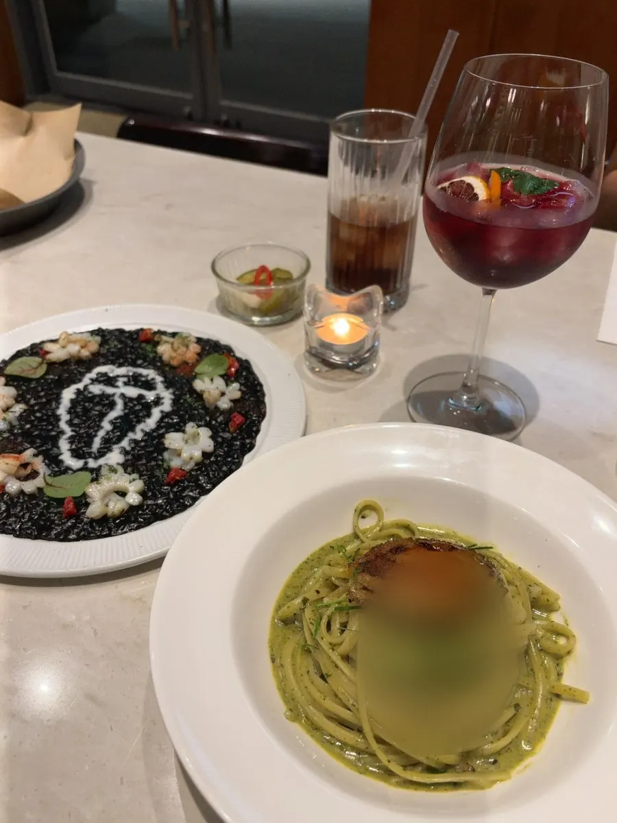 Eclipse squid ink risotto plated in a coffin shape