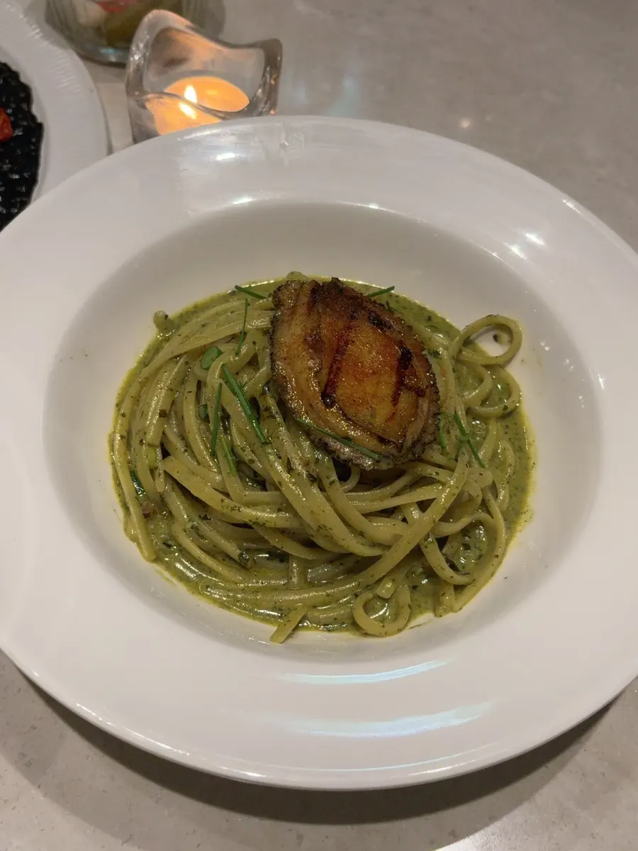 Abalone geou pasta topped with a whole abalone