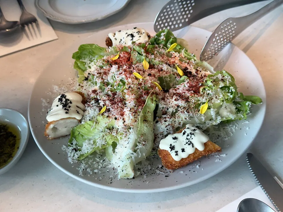 Caesar salad topped with chicken cordon