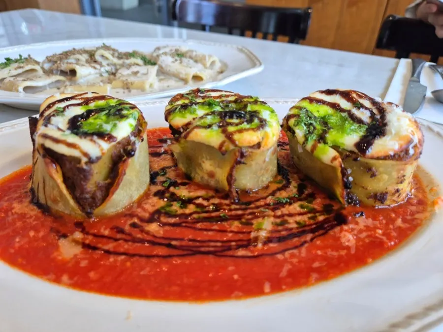 A plate of beef ragu fresh lazagna roll