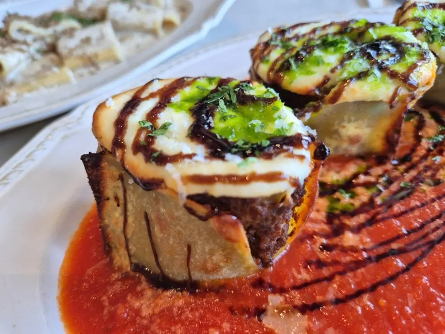 Cross-section of the lazagna roll with tomato sauce