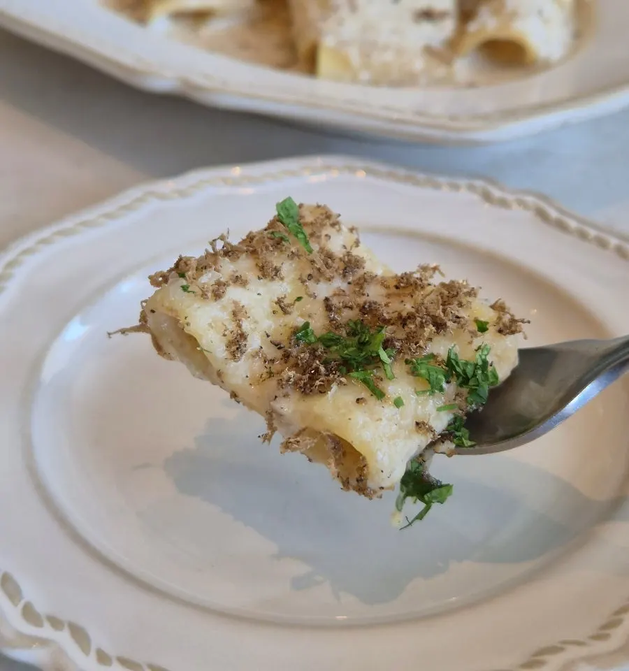 A single bite-sized portion of the truffle cream pasta