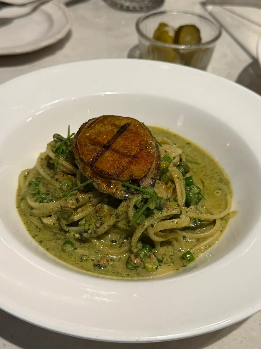 Pasta topped with golden-seared abalone