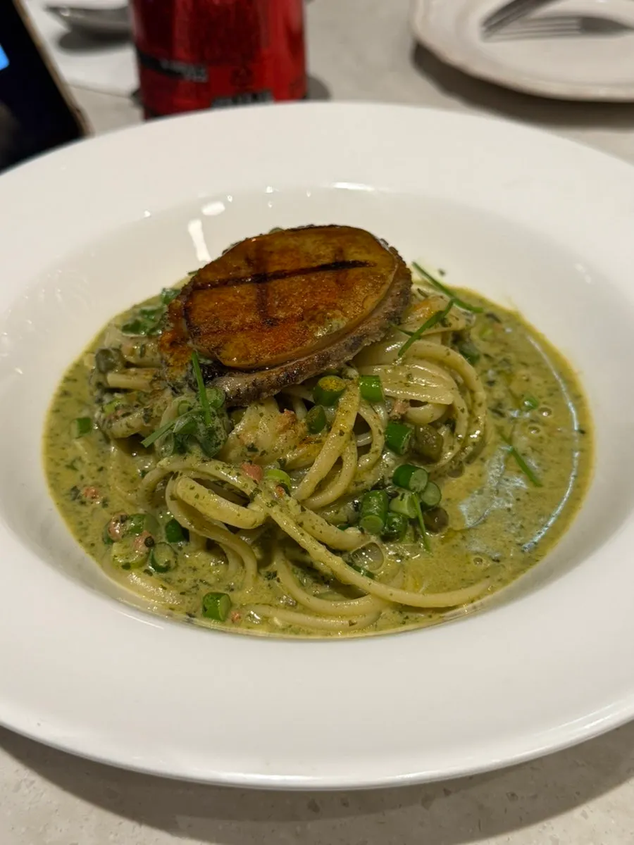 Close-up of abalone innard sauce soaked into the noodles