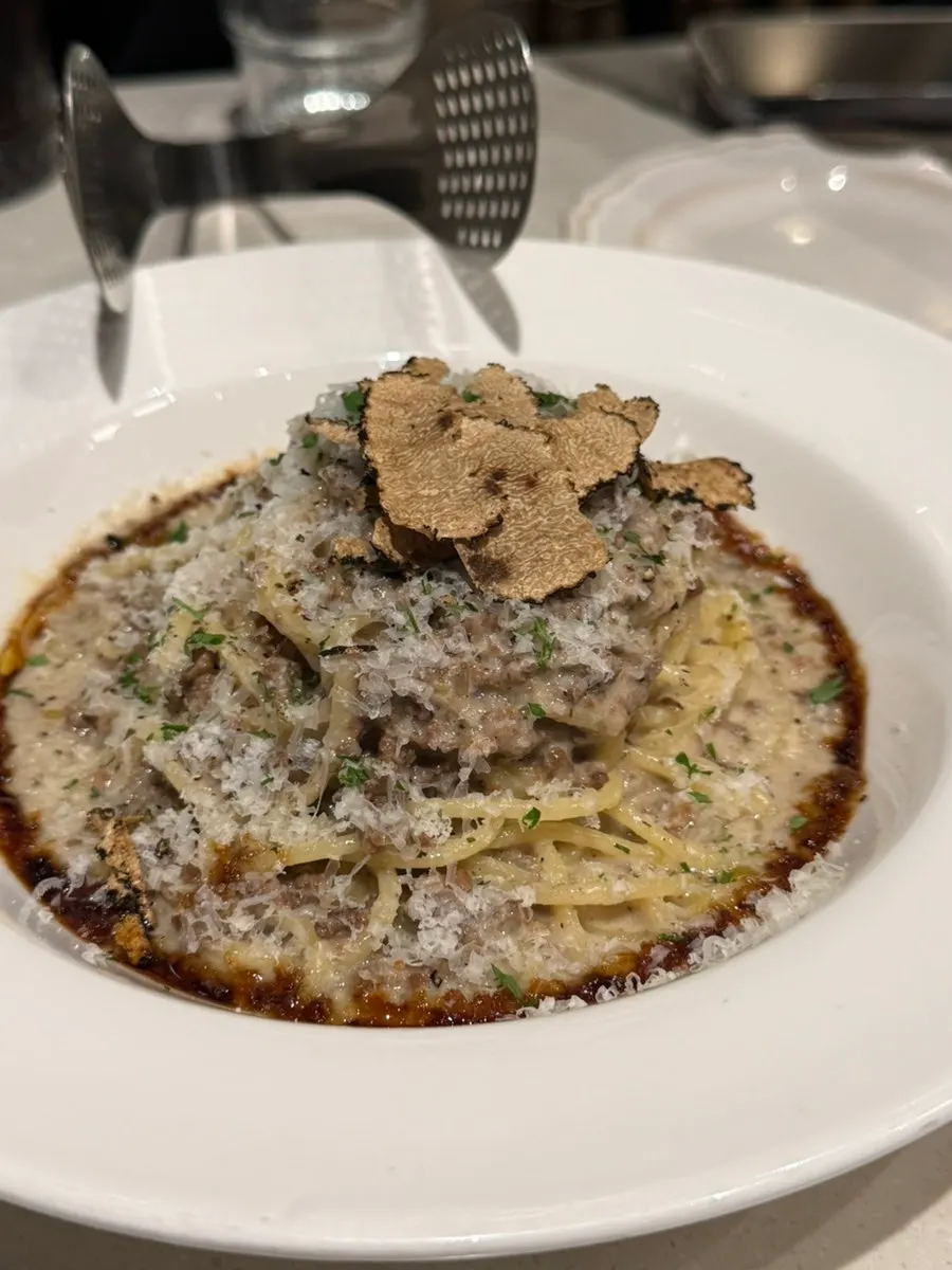 White ragu pasta covered generously with cheese
