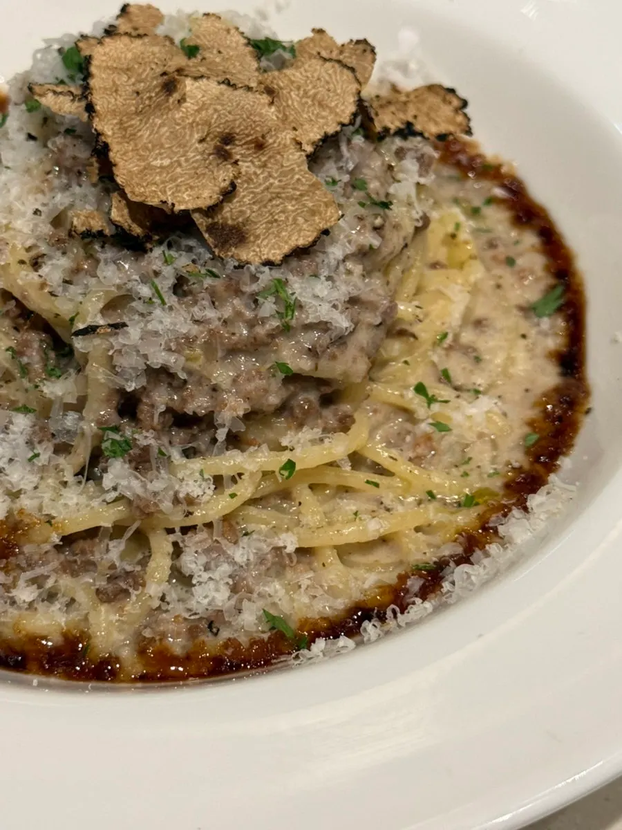 Thick ragu sauce clinging to the noodles