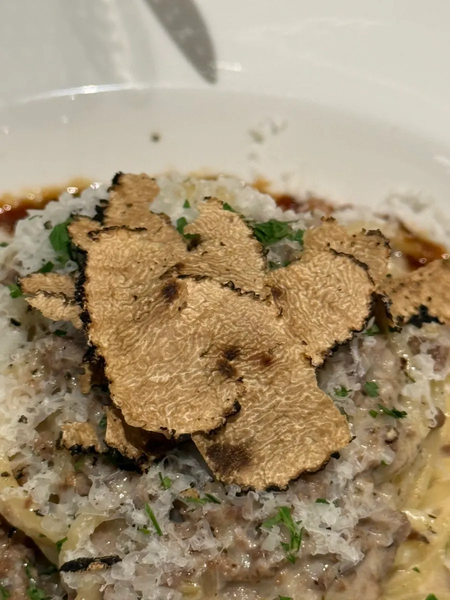 A plate of pasta with truffle aroma spreading