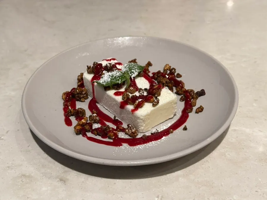 Dessert with caramelized nuts and berry sauce