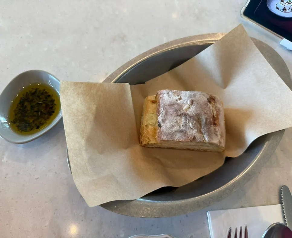 Table set with pre-meal bread and herb oil