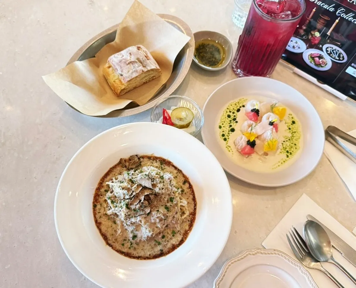 Full table spread with carpaccio and pasta served together