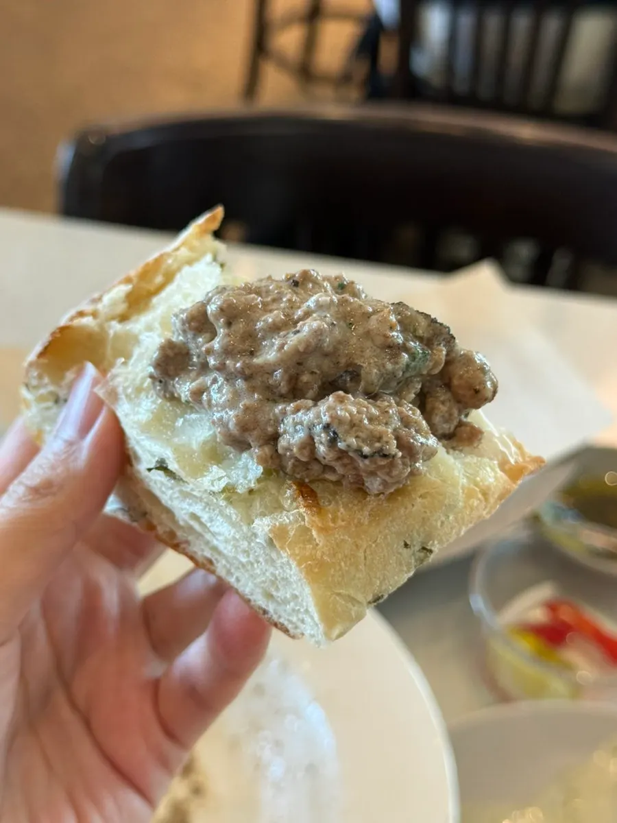 Pre-meal bread topped with Korean beef white ragu sauce