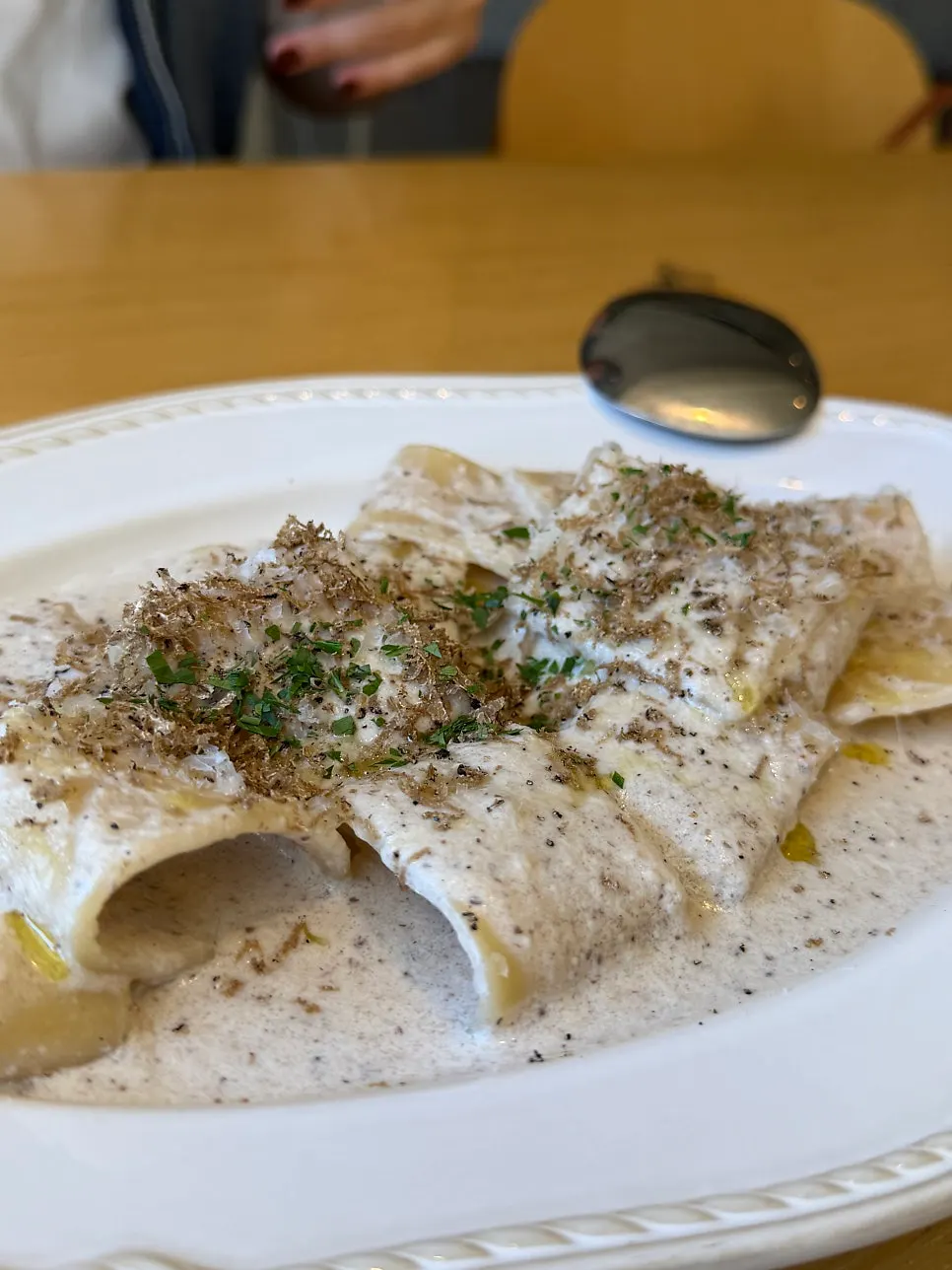 Scooping up a bite of the truffle cream pasta