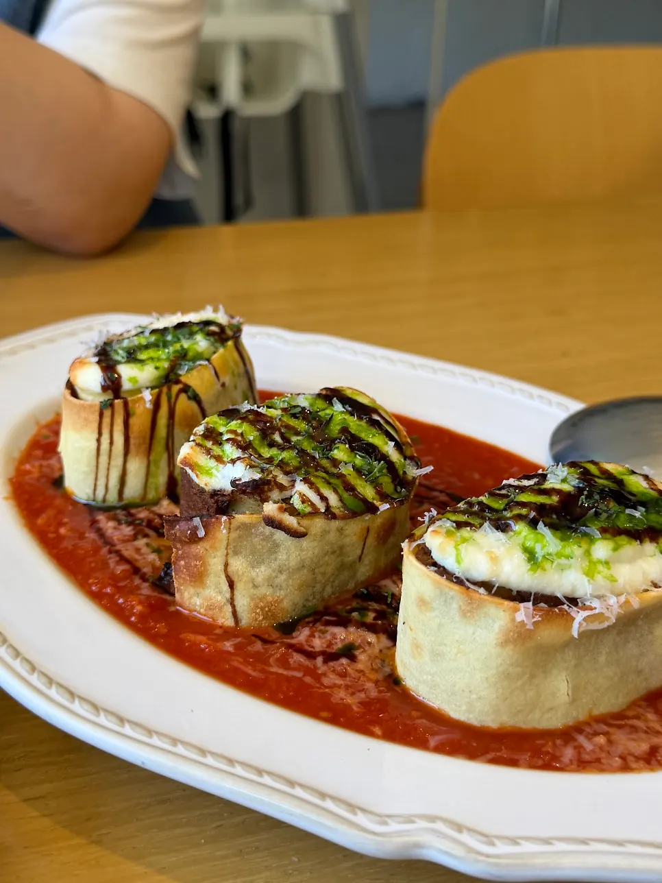 Close-up of the lasagna roll topped with tomato sauce