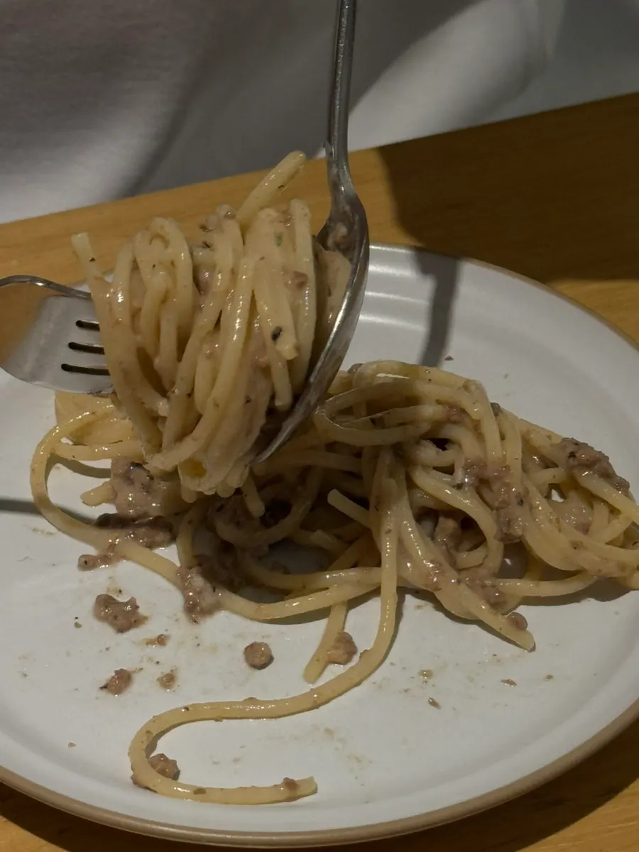 Close-up of Korean beef ragu pasta topped with truffle