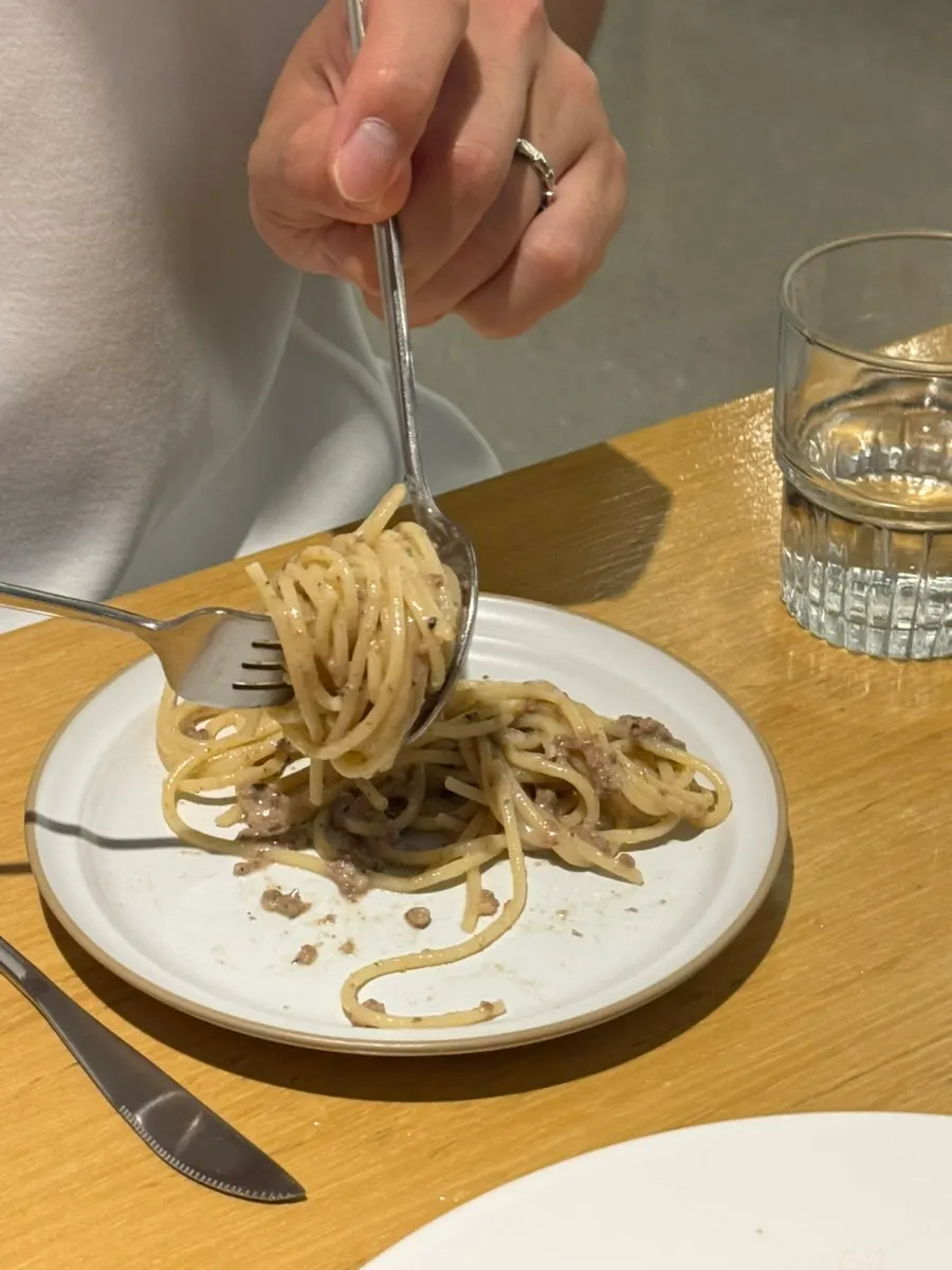 A plate of rich white ragu pasta