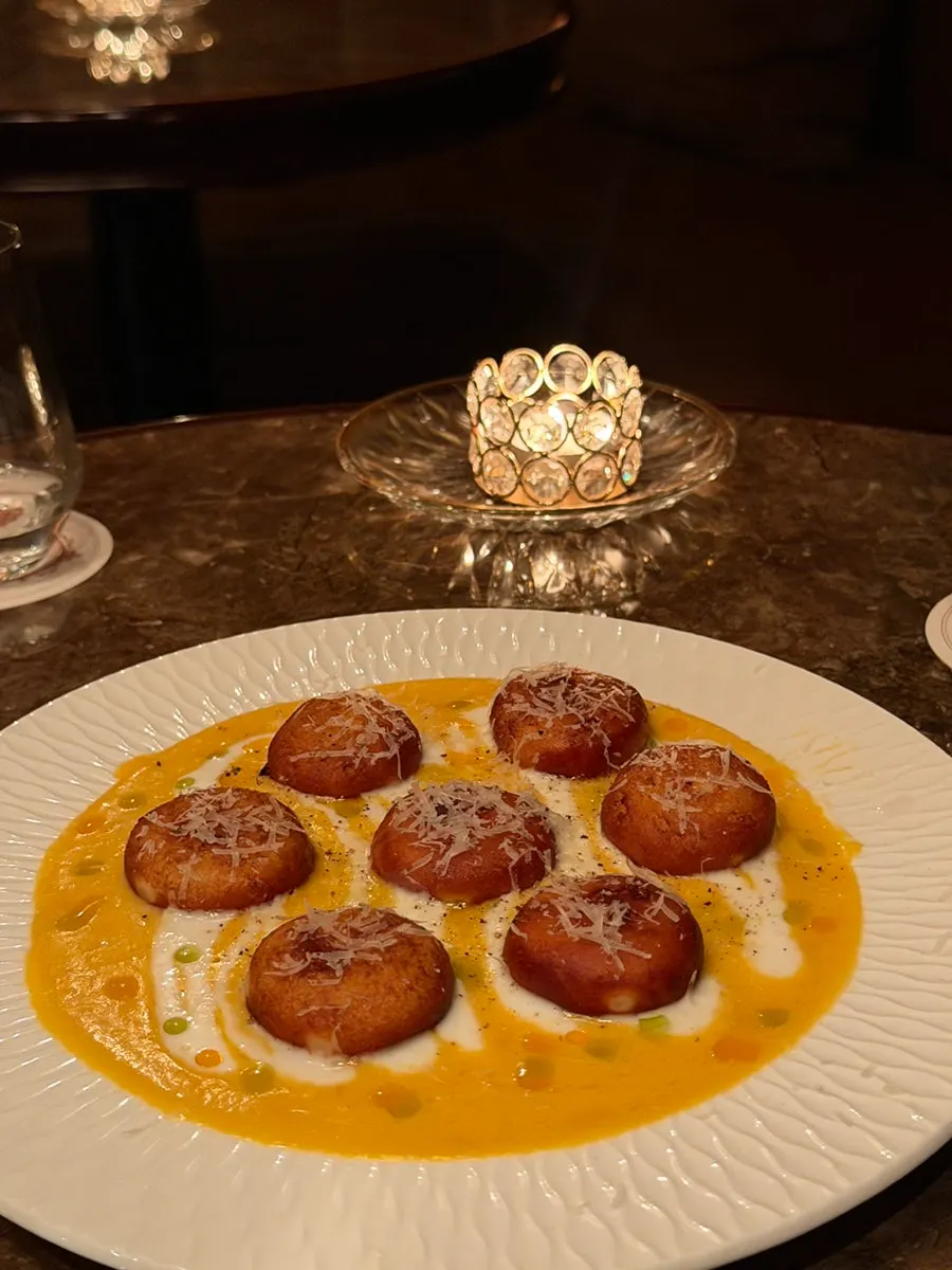 A plate of cream gnocchi topped with pumpkin purée