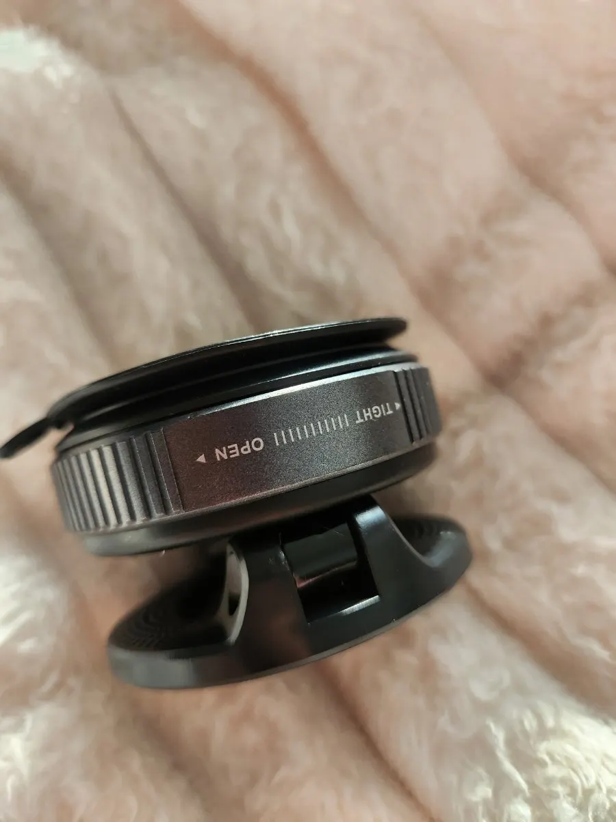 Car phone mount secured by suction to a dashboard