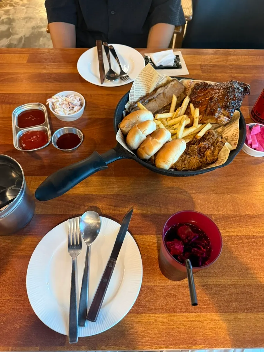 Cabbage salad, fries, and morning rolls on the side