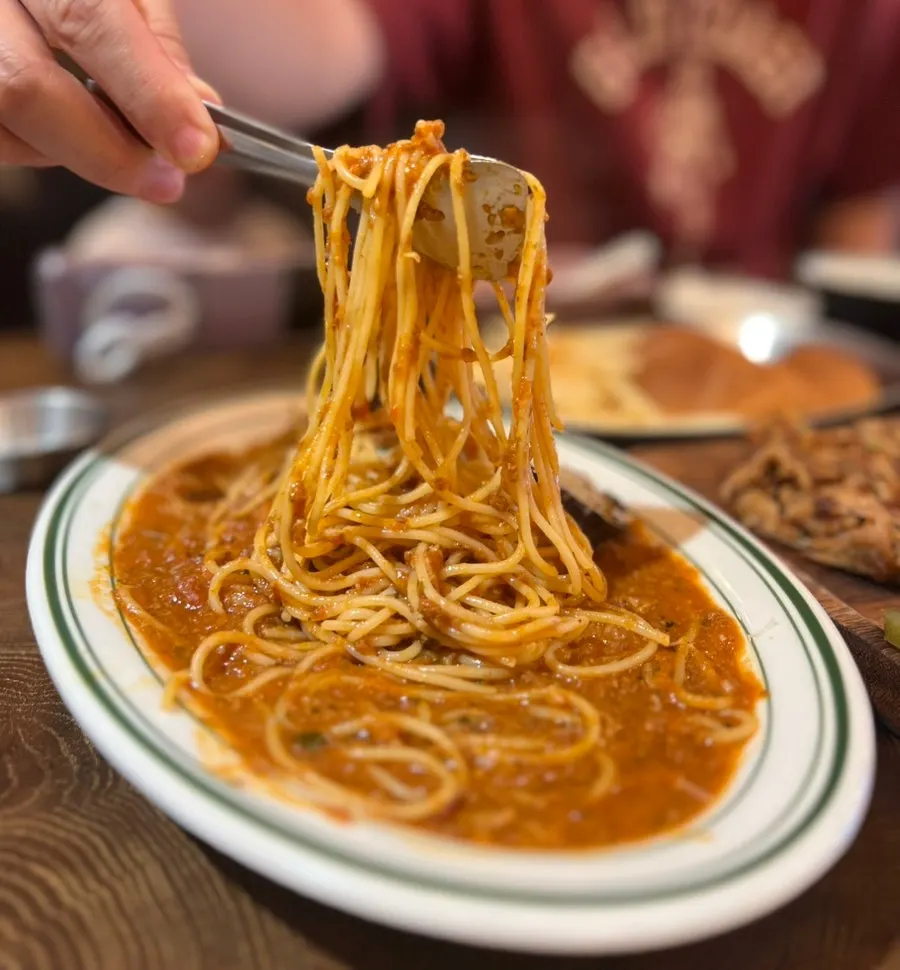 Close-up of tomato-based ragu pasta noodles