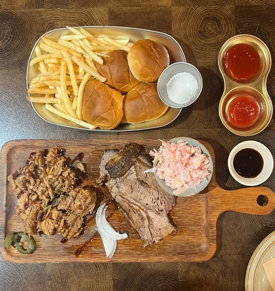 Table with BBQ and pasta served together
