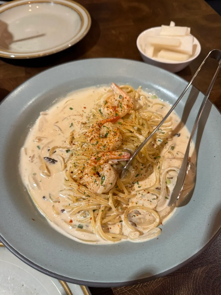 Toowoomba pasta topped with cream sauce and shrimp