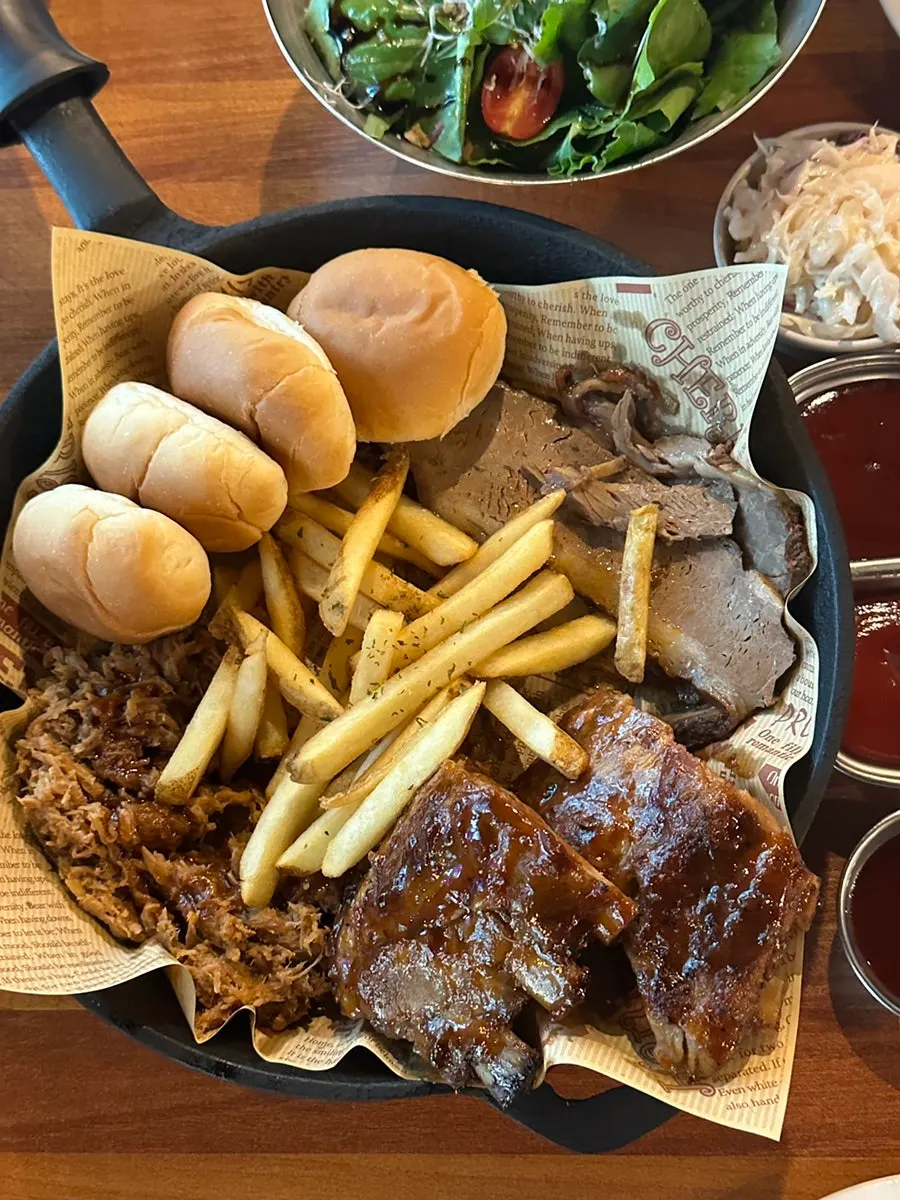 Tender pork ribs pulled off the bone with tongs