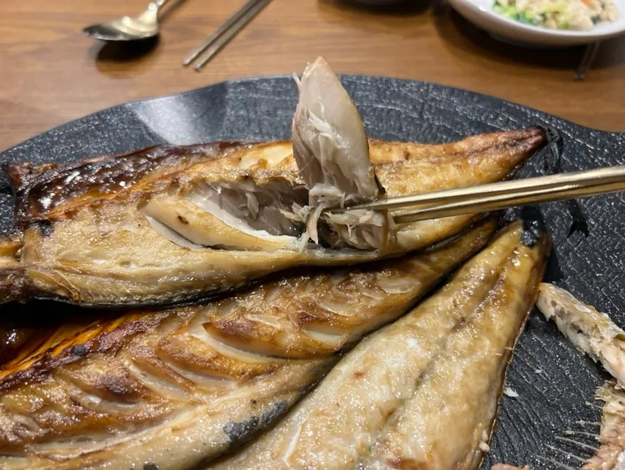 A spoonful of rice and grilled fish