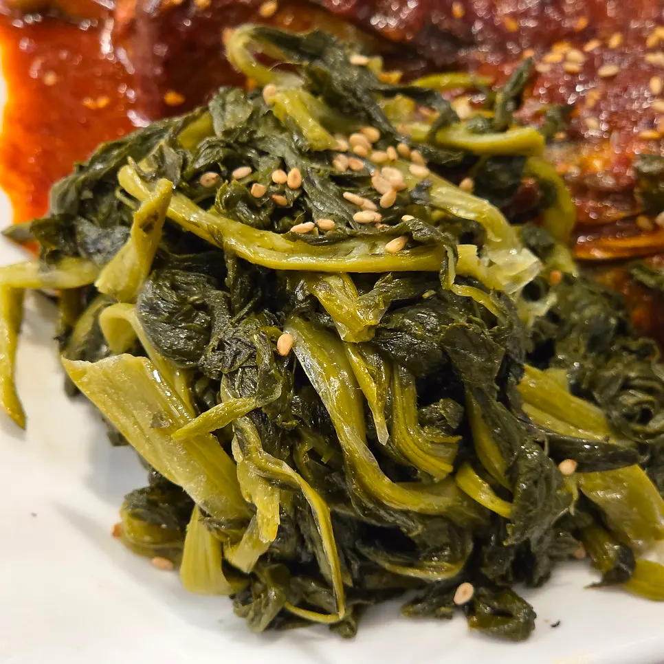 A bite of kodari wrapped in seaweed