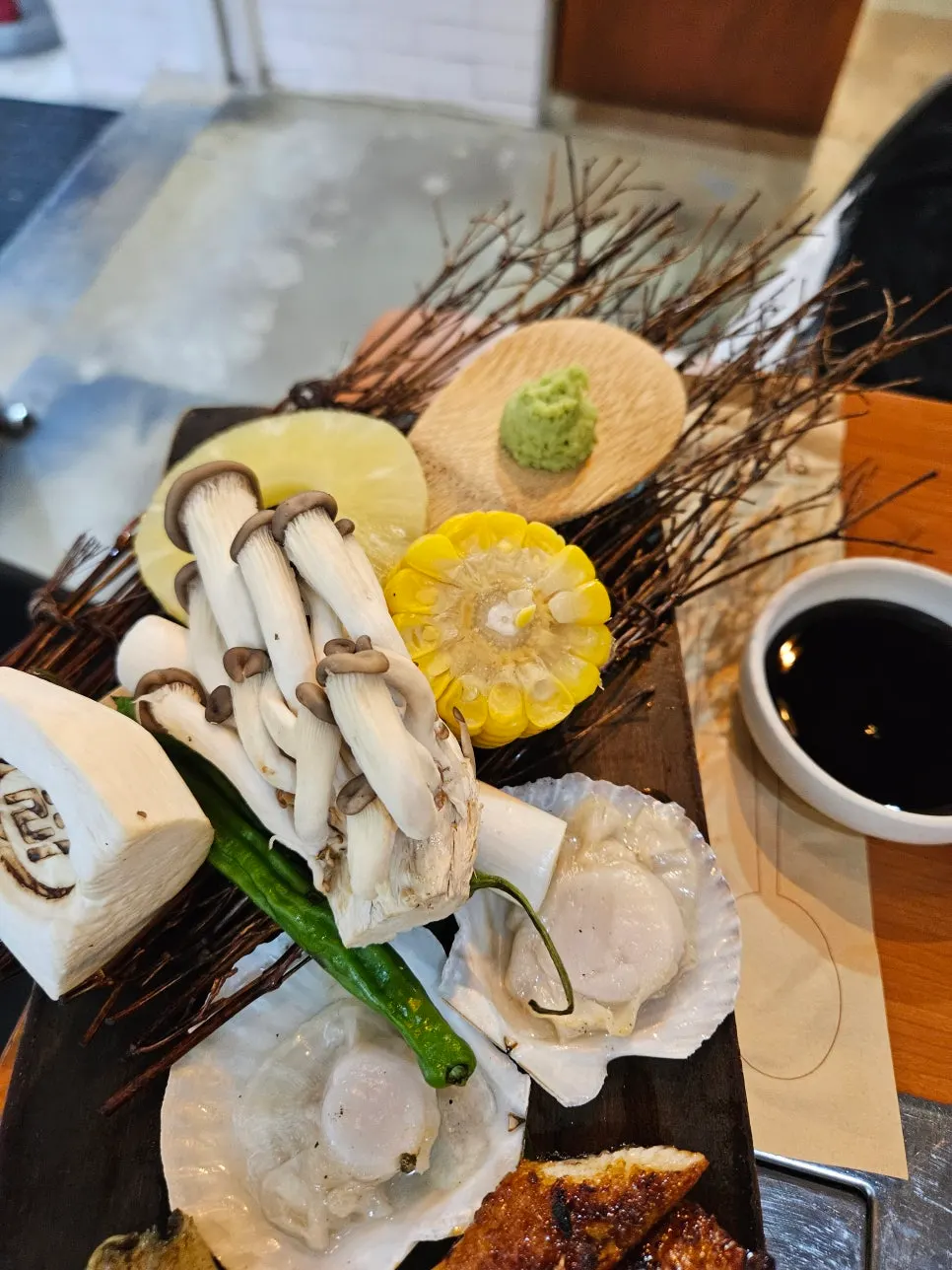 Grilled sides of scallop, corn, pineapple, and mushroom