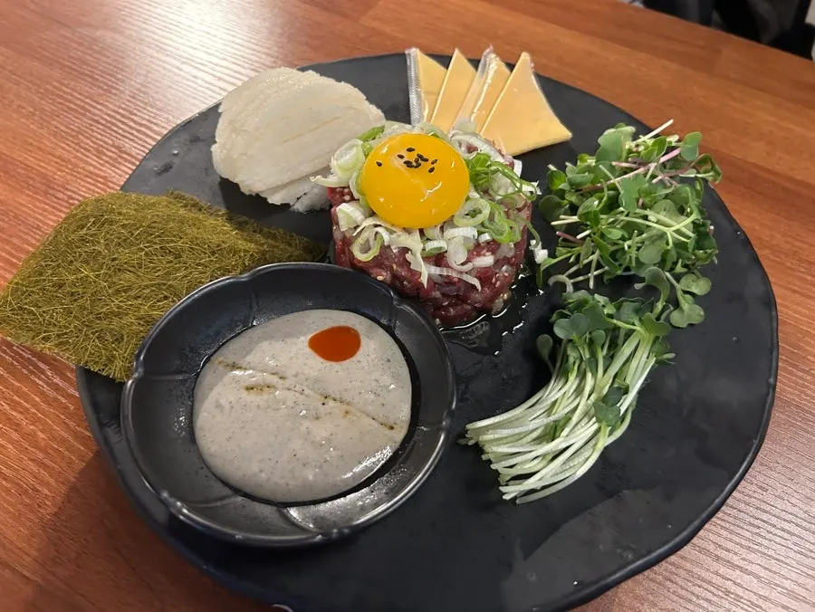 A bite of golbaengi somyeon piled with noodles
