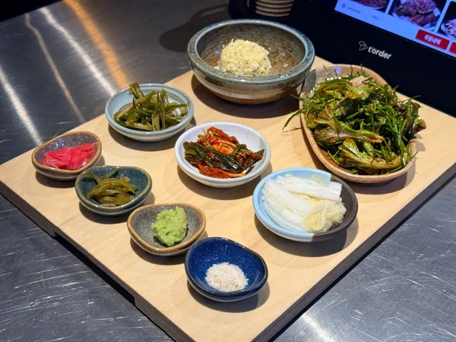 Side dish spread including white kimchi and salt-wasabi