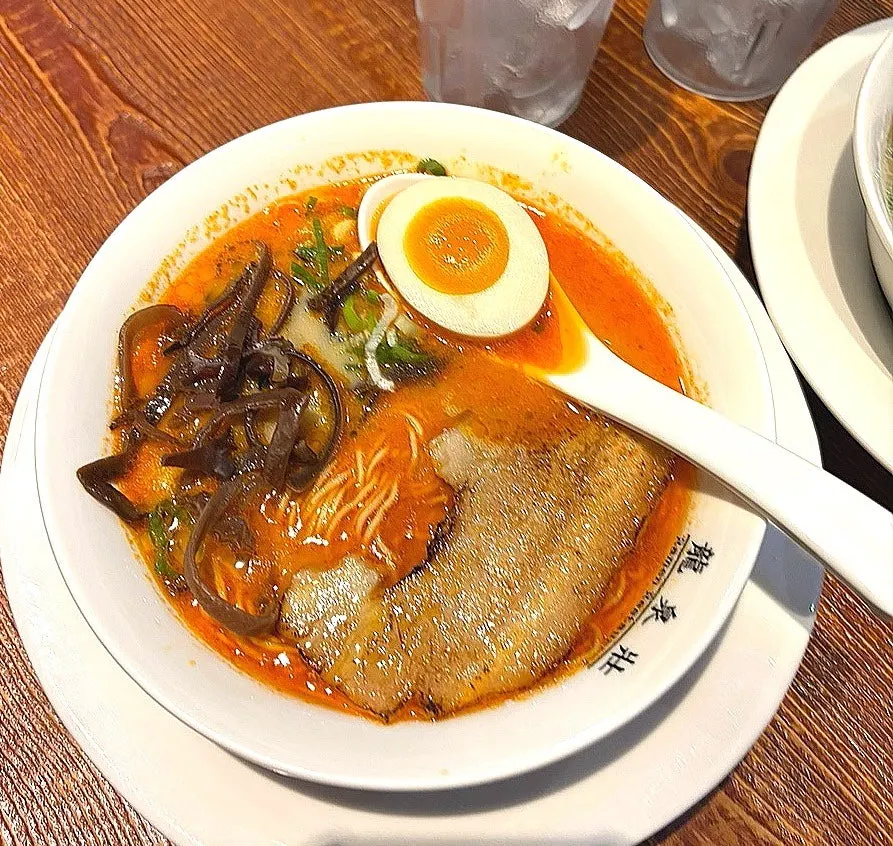 Close-up of the spicy tonkotsu ramen's red broth