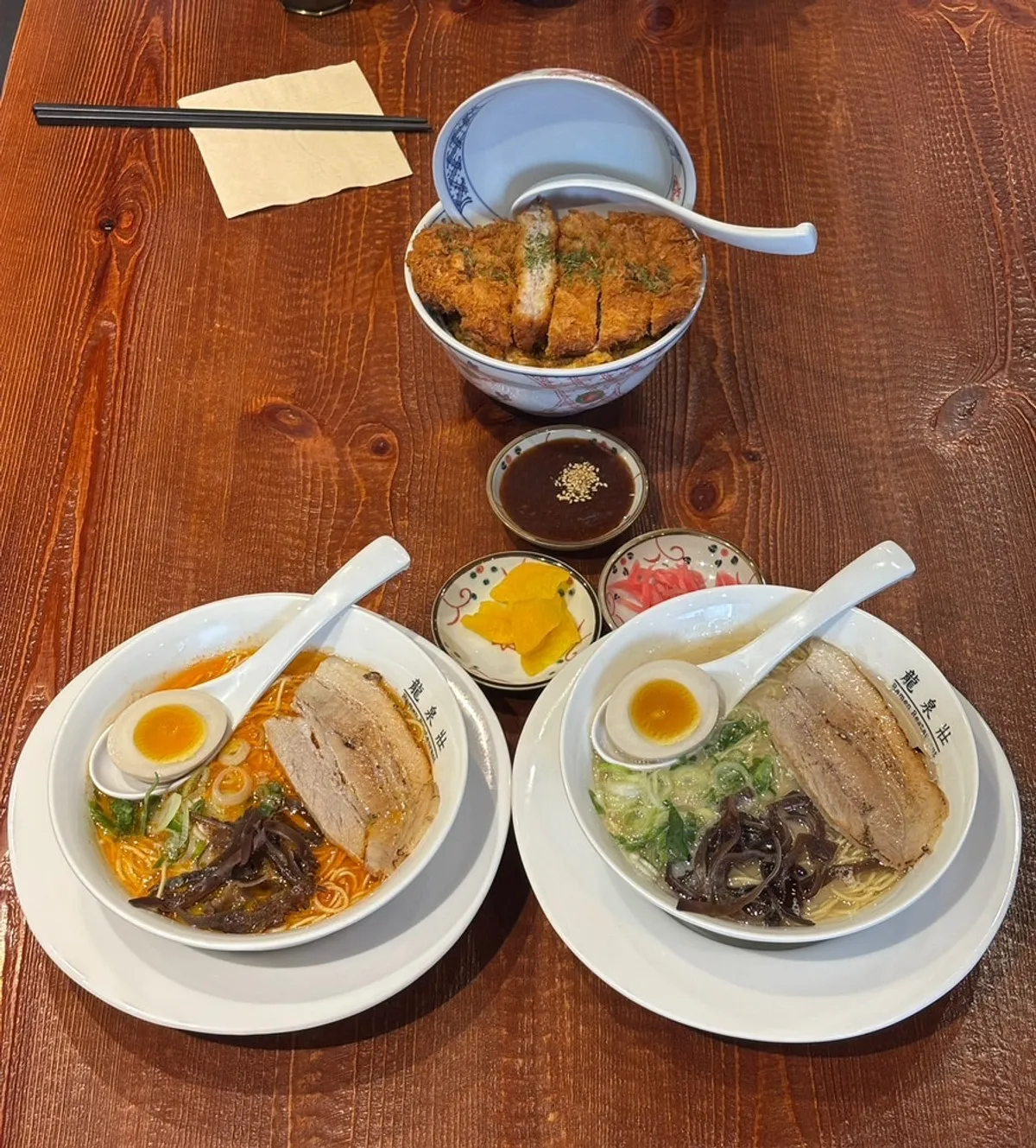 Two bowls of Ryusenso ramen and one katsudon on the table