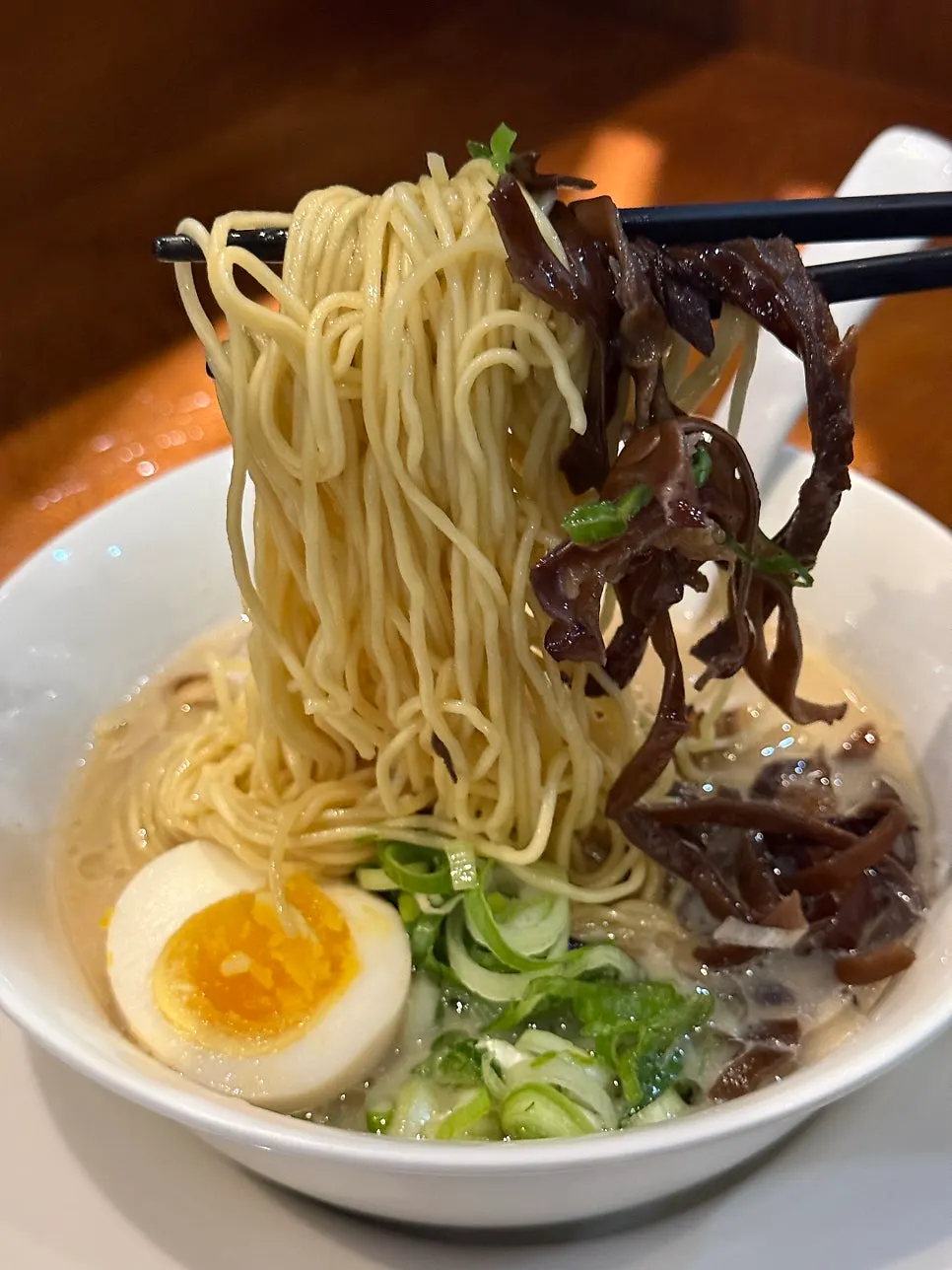 Noodles lifted up along with wood ear mushrooms