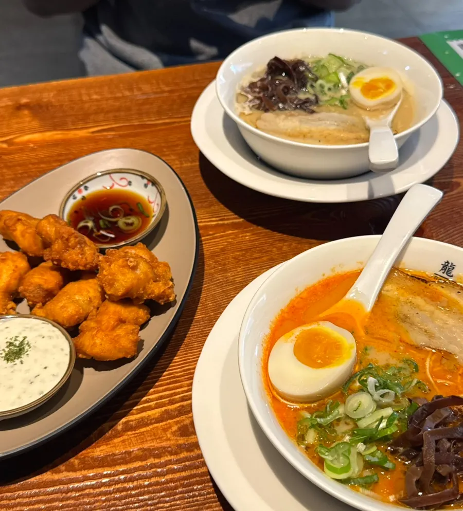 Two bowls of ramen and karaage on the table