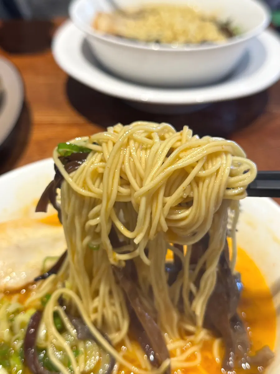 Lifting up the firm ramen noodles
