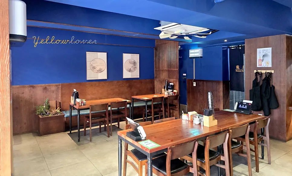 Interior with deep blue walls and wood-tone furniture