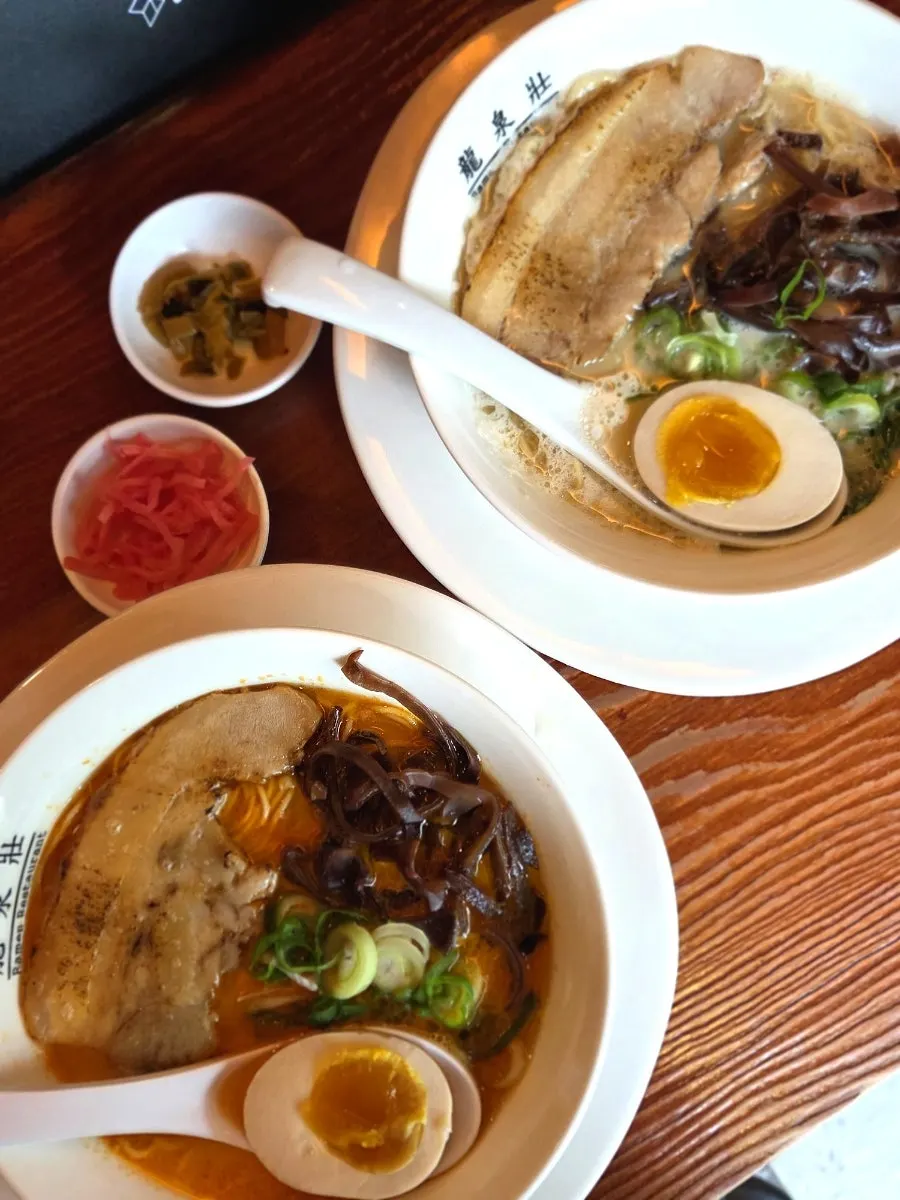 Ramen topped with soft-boiled egg, chashu, and wood ear mushroom strips