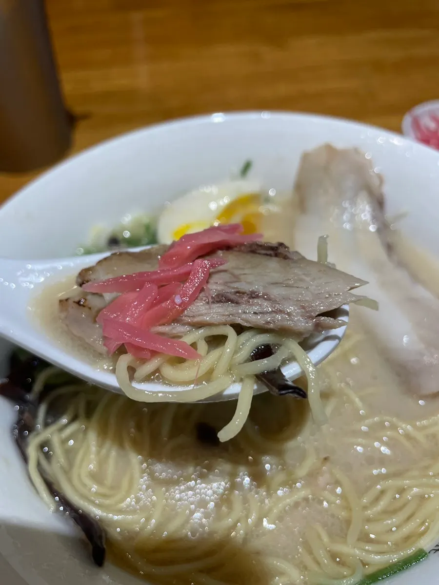 Noodles lifted out of the rich tonkotsu broth