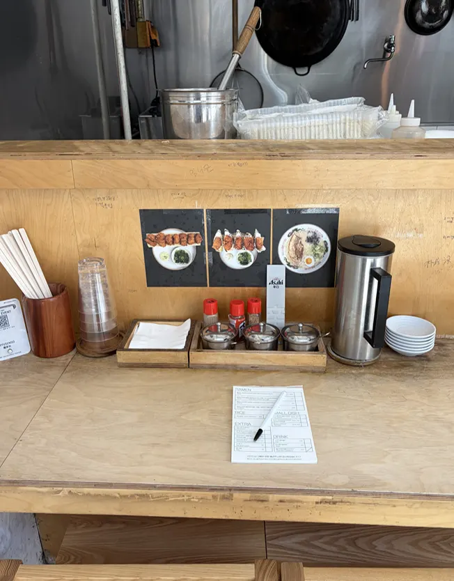 Counter seat set with condiments, order sheet, and water