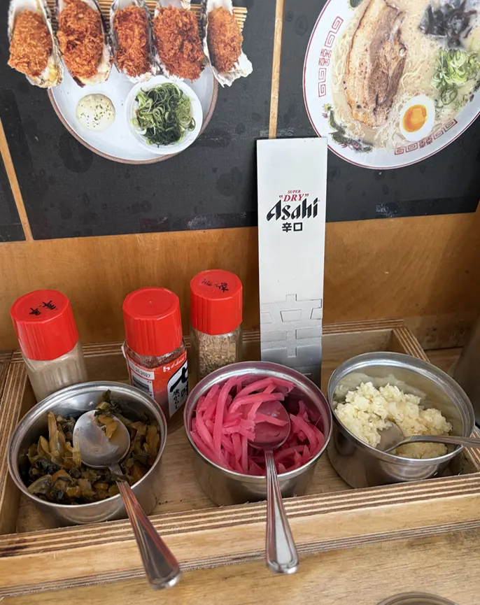 Side dish setup with pickled mustard greens and ginger
